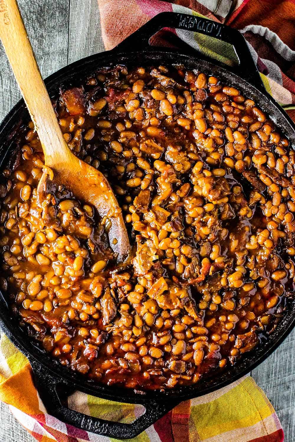 Stir the baked beans with a wooden spoon after they have baked. 