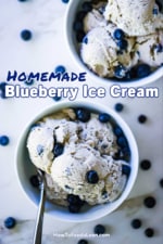 An overhead view of two ice cream bowls filled with homemade blueberry ice cream with fresh blueberries scattered all around the bowls.