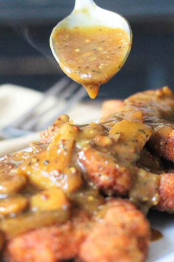 German Schnitzel with Mushroom Gravy on a white plate