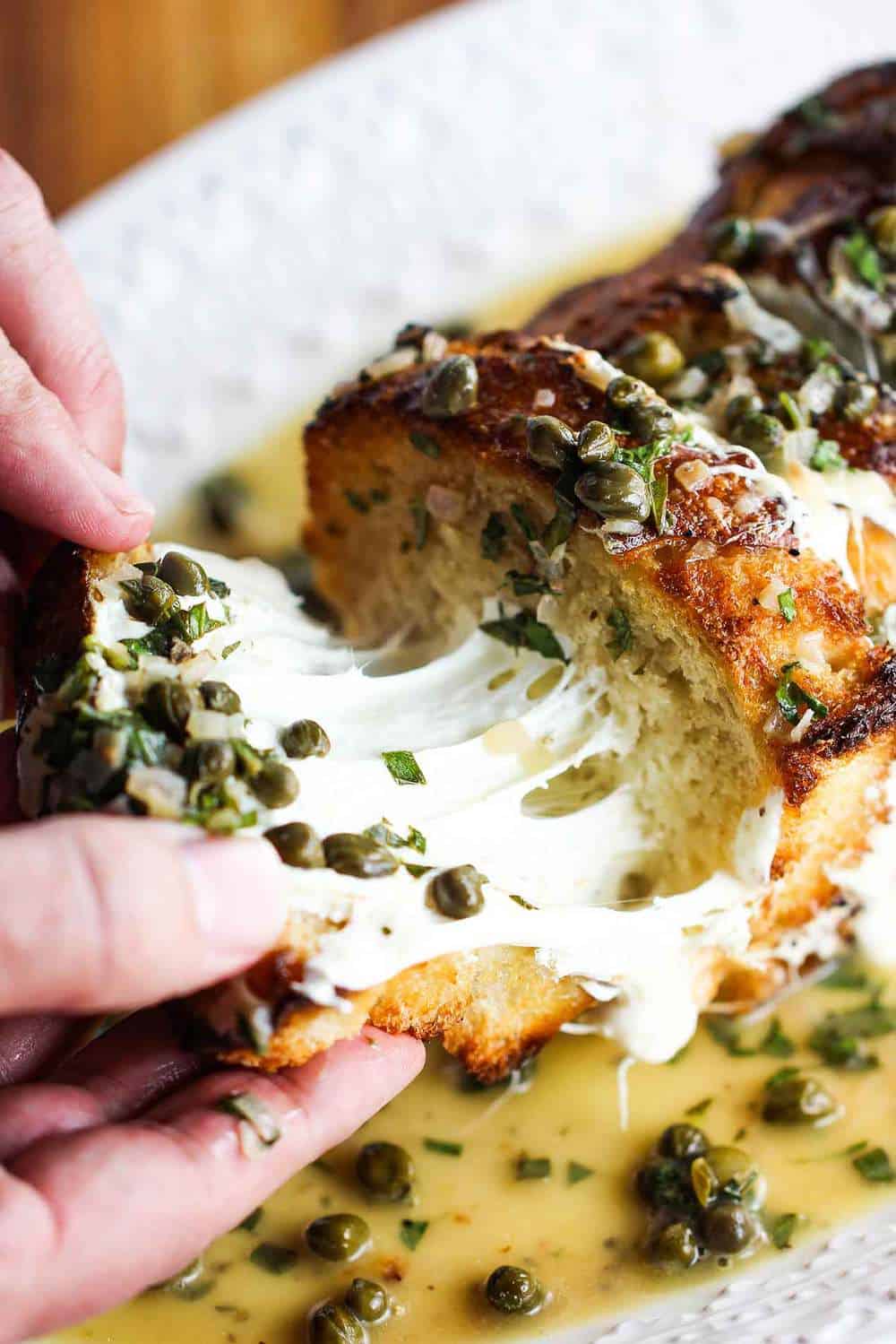 pull a slice of the spiedini alla Romana to get the gooey cheese and caper sauce