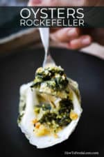 A spoon being held up with a spinach mixture in it from an oysters Rockefeller.