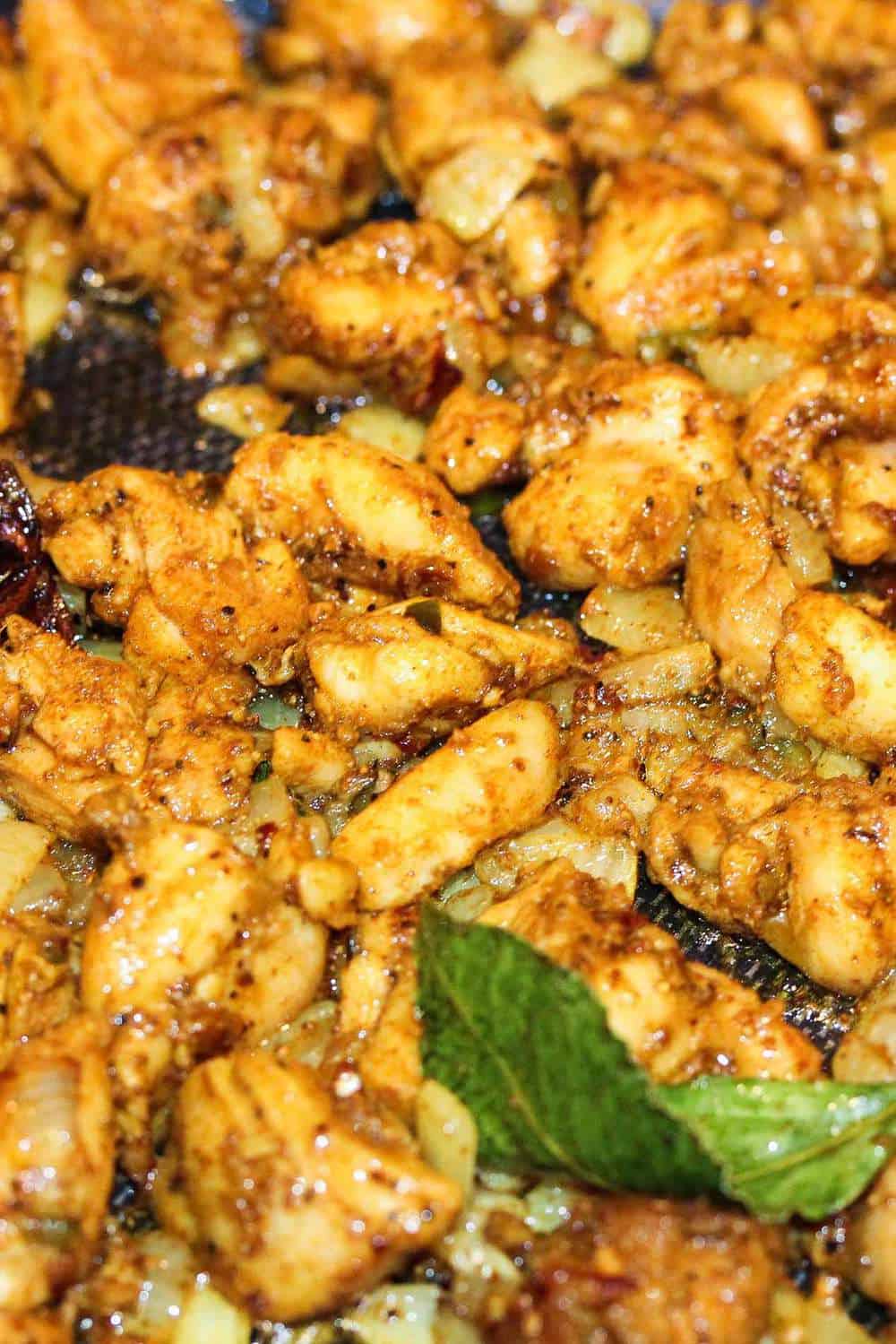 Cooked chicken with a bay leaf for authentic curry chicken