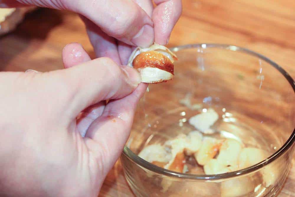 Roasted garlic being pressed out for German spaetzle