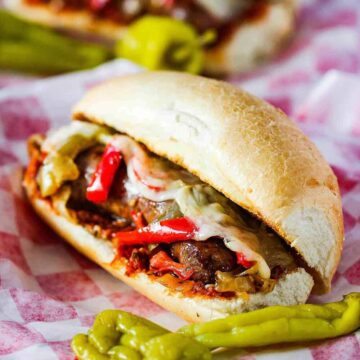 Sausage and Peppers Hero on a checkered napkin.