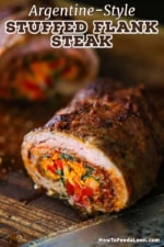 A close-up view of a sliced roasted rolled flank steak that has been stuffed with carrots, peppers, and herbs.