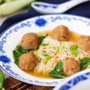 Asian Fusion Wedding Soup in a patterned bowl next to a dark napkin
