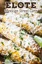 A straight-on view of a row of elote which is grilled corn slathered with a cream and mayonnaise sauce and topped with chopped cilantro.