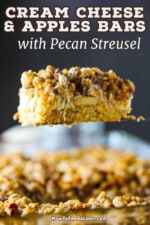 A side view of a cream cheese and apples bar being raised with a spatula from a dish filled with the dessert.