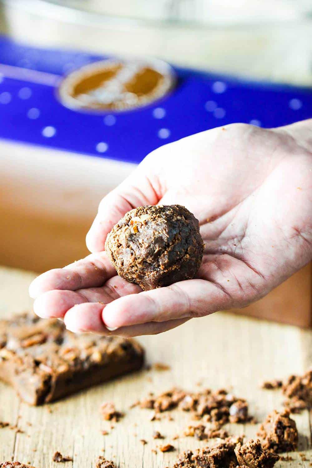 A brownie fritter in the palm of a hand. 