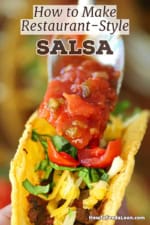 A person using a spoon to top a beef taco with restaurant-style salsa.