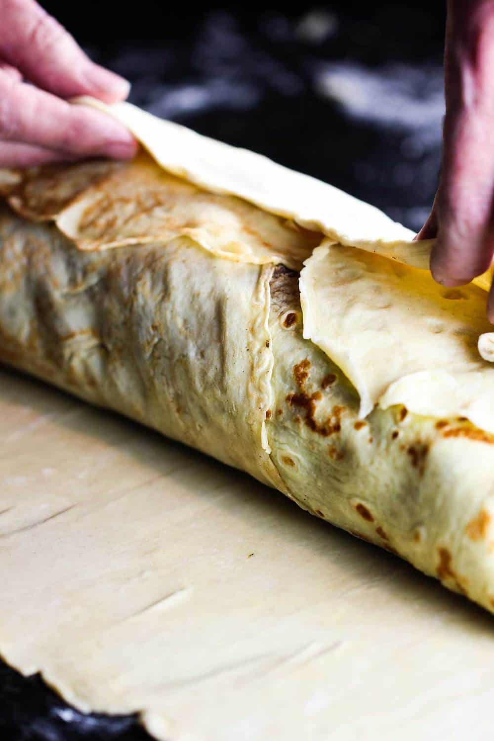 Pastry being wrapped around the classic beef Wellington