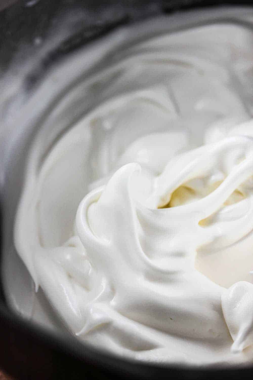 Freshly made meringue in a silve pan for banana pudding trifle.