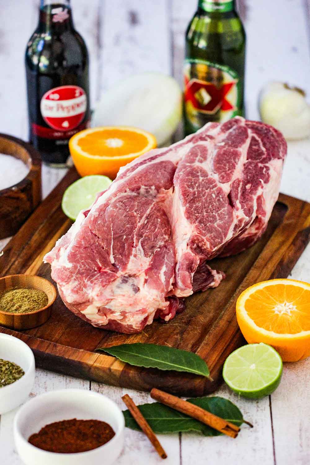 pork shoulder with citrus, herbs, Dr. Pepper and beer are used to slow cook the pork. 