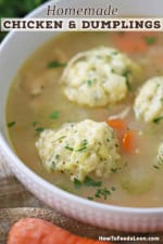 A close-up view of a white soup bowl that is filled with homemade chicken and dumplings soup that has been garnished with chopped fresh parsley.