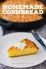 A slice of homemade cornbread on a white plate with a pad of butter on top.