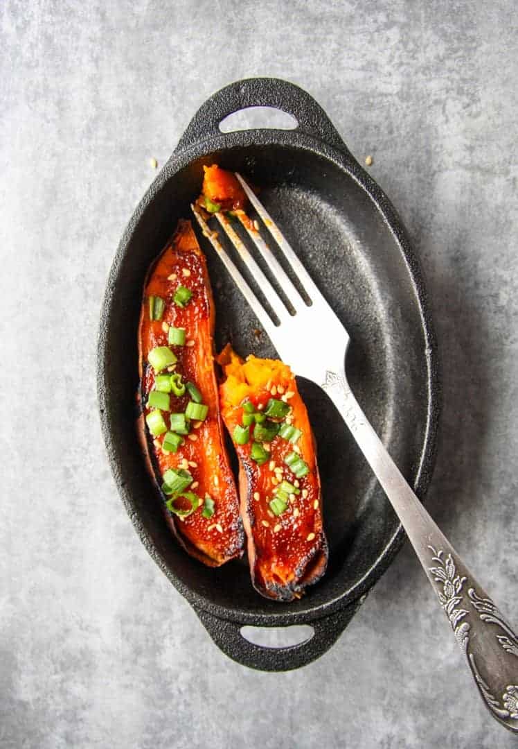 Baked yams in a pan with a fork