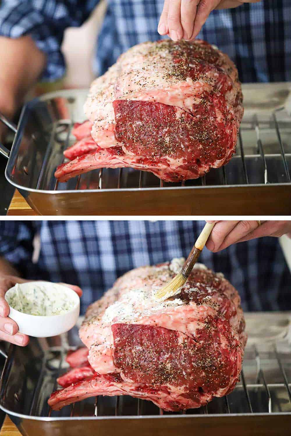 A person adding salt and pepper to a standing prime rib roast in a roasting pan, and then brushing it with an herbed butter compound. 
