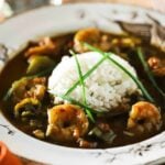 A white bowl filled with shrimp and okra gumbo.