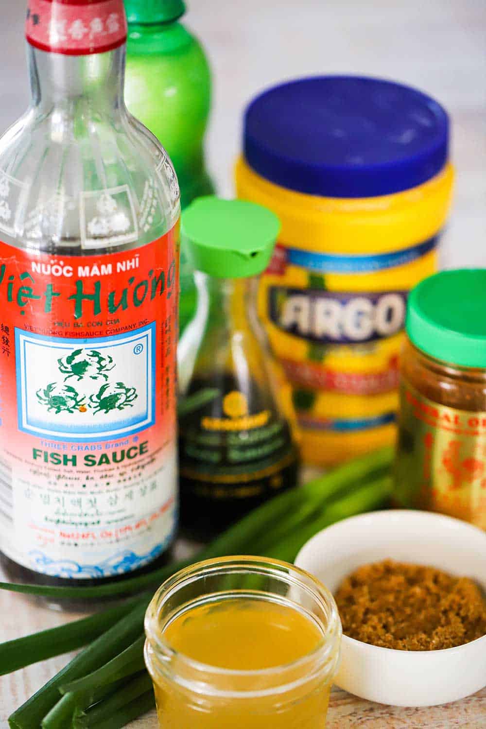 Bottles and various ingredients for Hot and Sweet Dipping Sauce all sitting next to each other. 