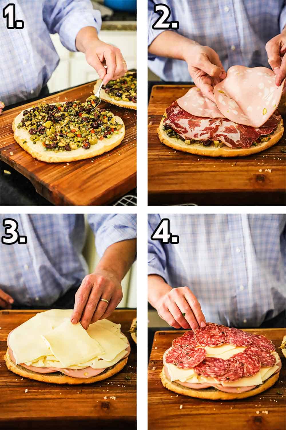 A person adding olive salad to a halved circular loaf of bread, and then cured meats being added, then cheese, and then more meats.