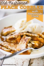 A side view of a white dessert bowl filled with old fashioned peach cobble with crust and two scoops of vanilla ice cream on top.