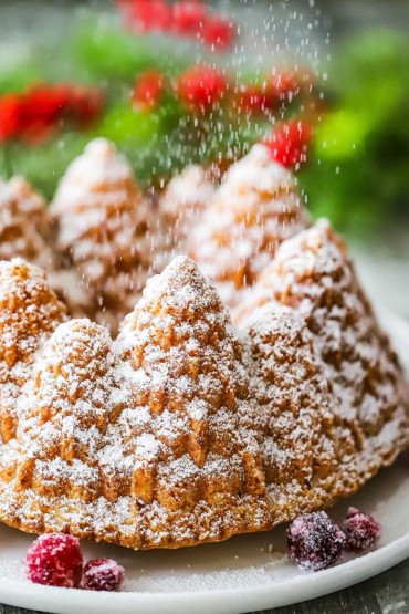 Powdered sugar being sprinkled over the tops of a Christmas bundt cake.