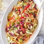 An overhead view of an oval white platter filled with an Asian slaw with Peanut Ginger Dressing.