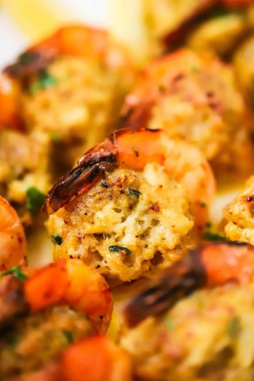 A close-up view of a baked shrimp that is stuffed with a crab mixture.