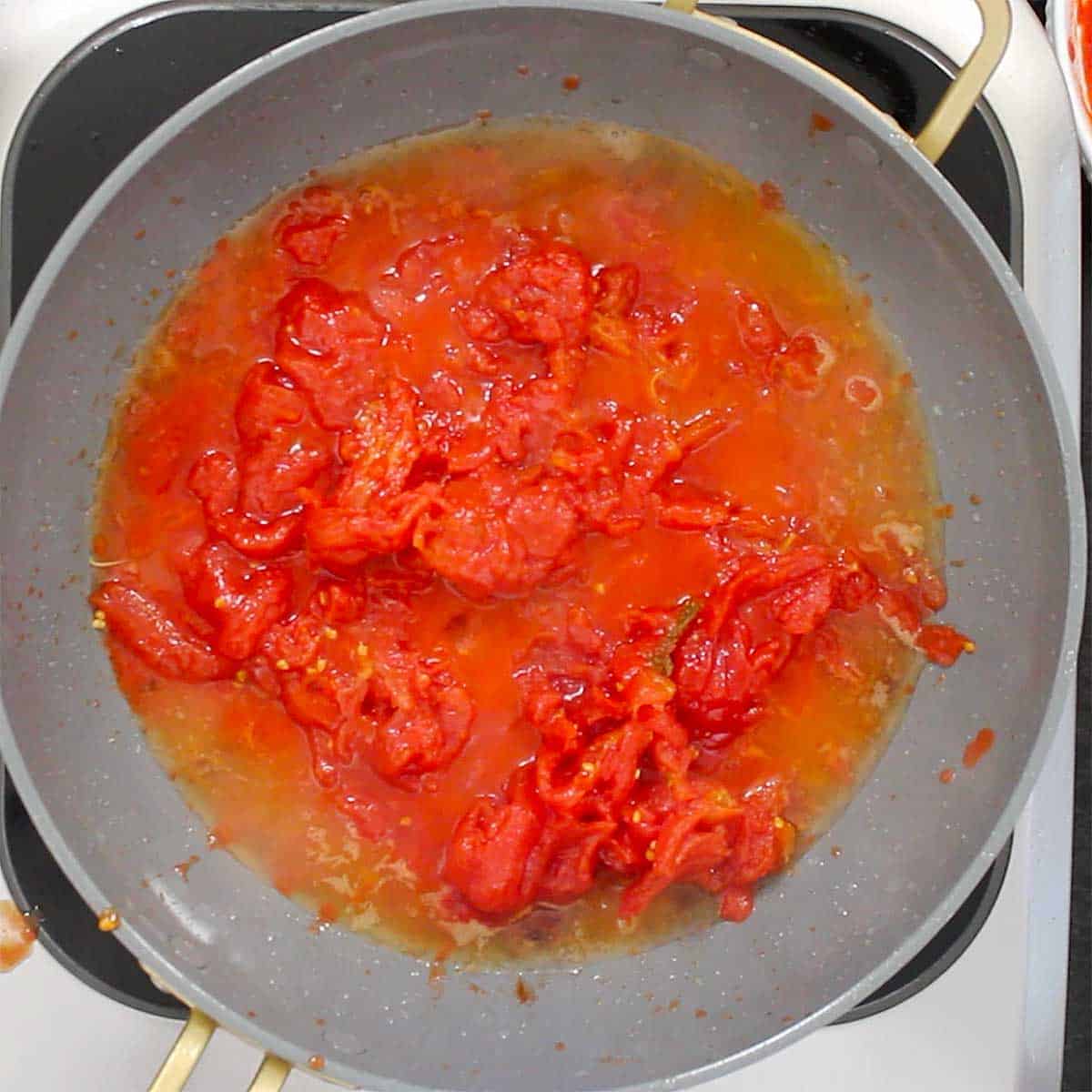 A skillet filled with hand-squeezed San Marzano tomatoes. 