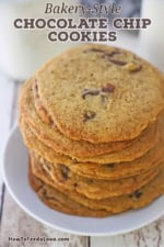 A stack of bakery-style chocolate chip cookies on a white dessert plate.