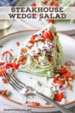 A partially eaten steakhouse wedge salad on a white plate with iceberg lettuce, cherry tomatoes, crumbled bacon, and blue cheese dressing.