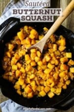 A wooden spoon inserted into the center of a skillet filled with Maple-Glazed Butternut Squash with Pancetta and Herbs.