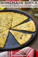 A black plate holding easy homemade socca with several slices missing.