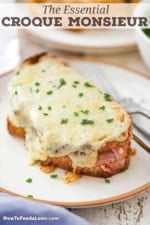 A close-up view of a freshly made Essential Croque Monsieur and is garnished with a sprinkling of snipped chives.