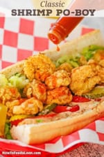 Louisiana hot sauce dripping out of a bottle onto a classic New Orleans Fried Shrimp Po-boy