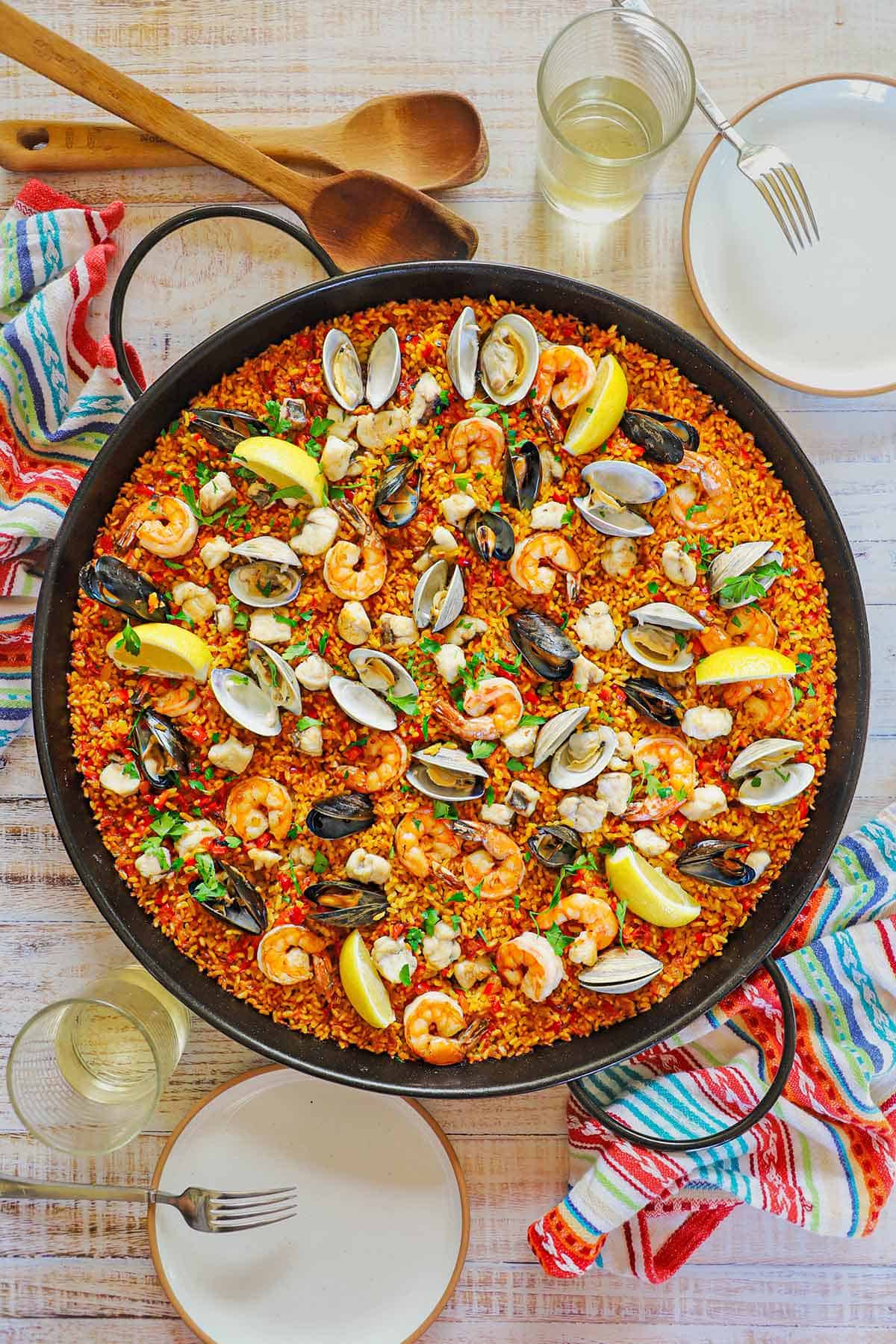 An overhead view of a large paella pan filled with freshly prepared Authentic Spanish Seafood Paella.