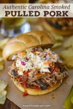 A straight-on view of a smoked pulled pork sandwich that is topped with Carolina BBQ sauce and homemade coleslaw.