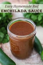 An open jar filled to the top with Easy Homemade Red Enchilada Sauce.