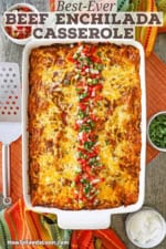 An overhead view of a 9 by 13 inch casserole dish filled with beef enchilada casserole with a row of pico de gallo and chopped cilantro running down the middle of it.