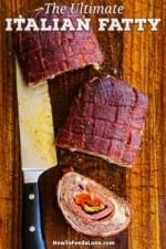 An overhead view of three large pieces of a Smoked Italian Fatty that with one piece laying on its side revealing the layers of Italian meat, cheese, and roasted veggies on the inside.