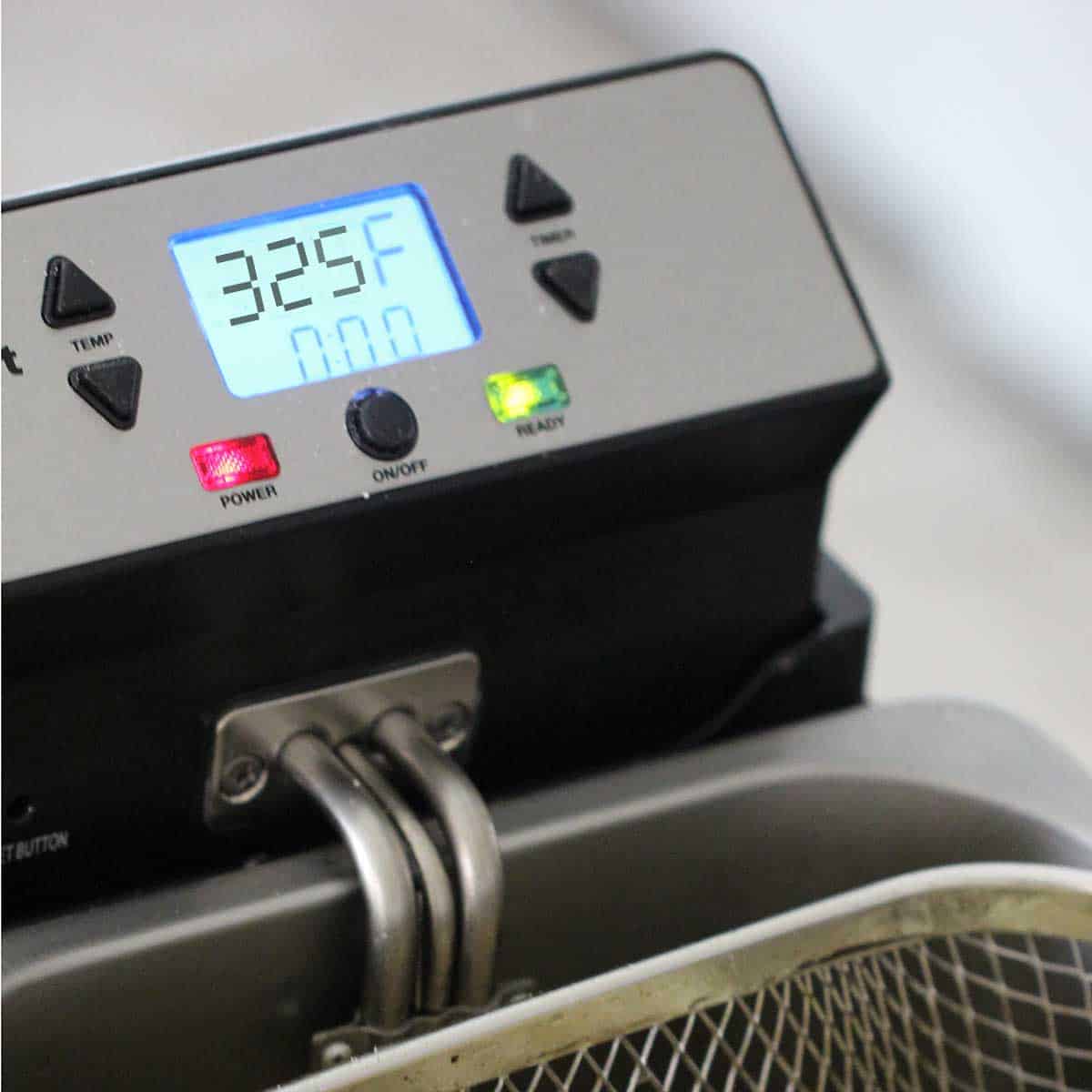 A close-up view of a deep fryer that is set to 325°F.
