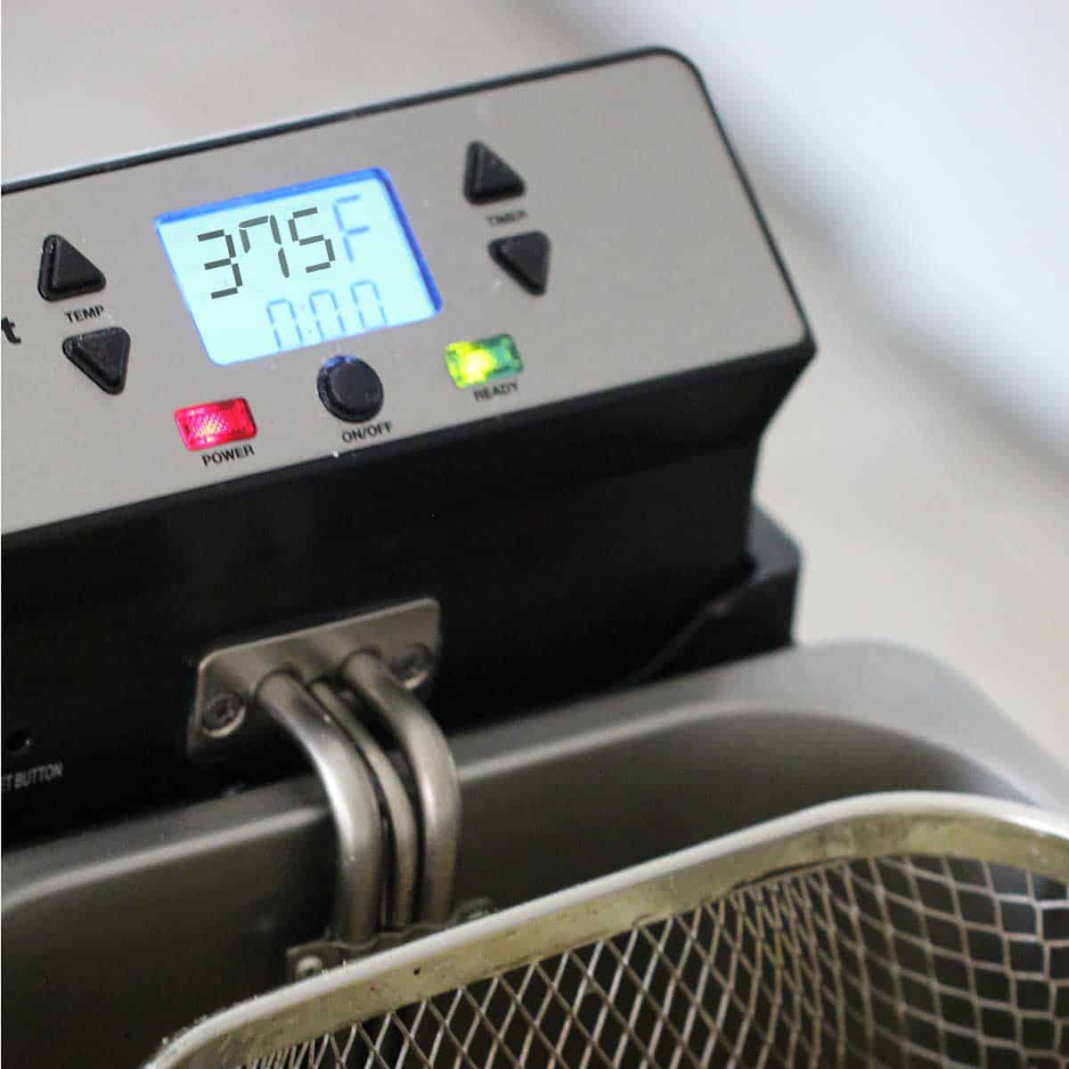 A close-up view of a deep fryer that is set to 325°F.