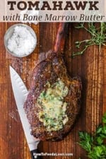 An overhead view of a reverse seared tomahawk steak with bone marrow butter that has melted on top of the steak.